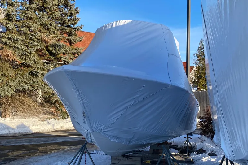The Image of 2025 Sea Pro 222 Center Console boat covered in protective wrap, outdoors in winter setting. - 0