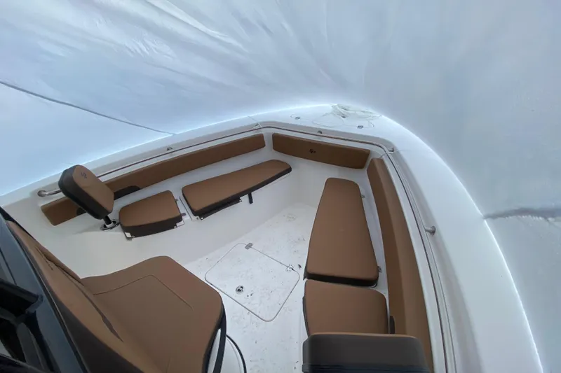 Slide: The Image of 2025 Sea Pro 222 Center Console boat interior with brown seating and white deck. - 10