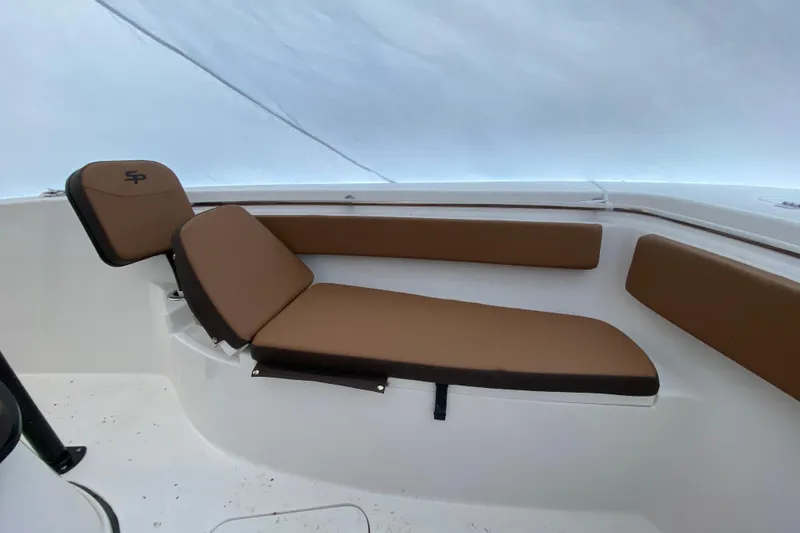 Slide: The Image of 2025 Sea Pro 222 Center Console boat with brown cushioned seating. - 11