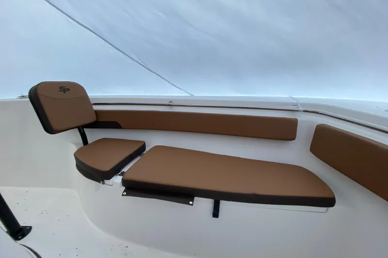 Slide: The Image of 2025 Sea Pro 222 Center Console boat interior with brown cushioned seating. - 12