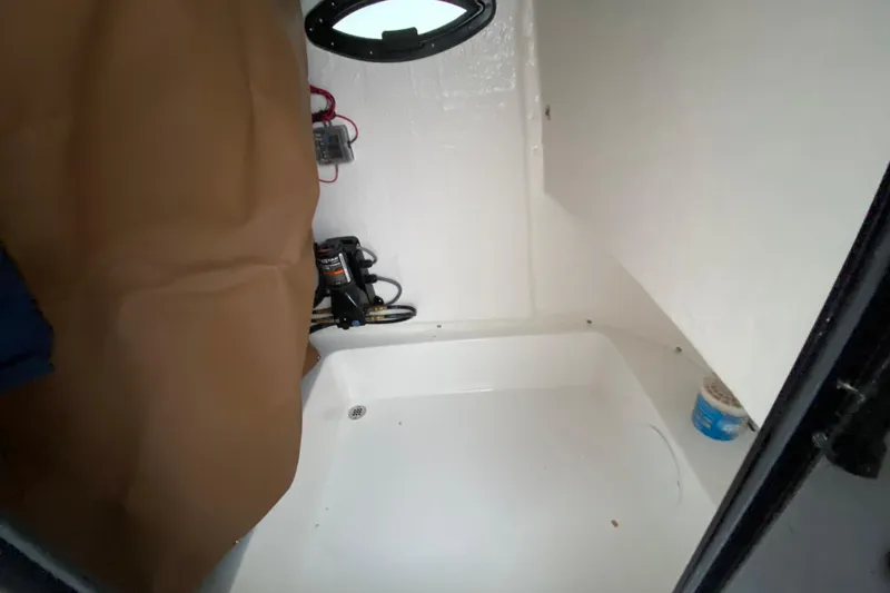 Slide: The Image of Interior of 2025 Sea Pro 222 Center Console boat, featuring storage and equipment space. - 13