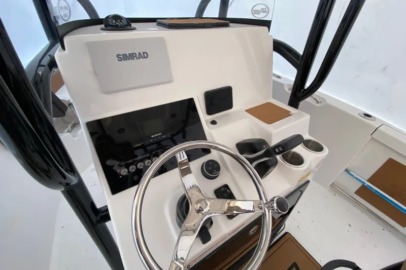 Slide: The Image of 2025 Sea Pro 222 Center Console boat dashboard with steering wheel and controls. - 5