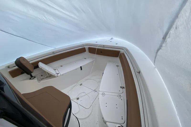Slide: The Image of 2025 Sea Pro 222 Center Console boat interior with white and brown seating. - 9