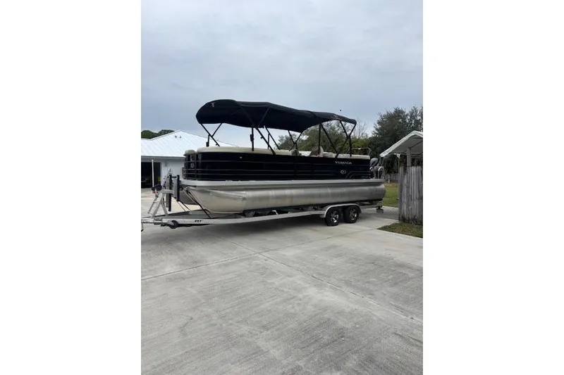 The Image of 2022 Veranda Vista 22RC pontoon boat on trailer, parked in driveway. - 0