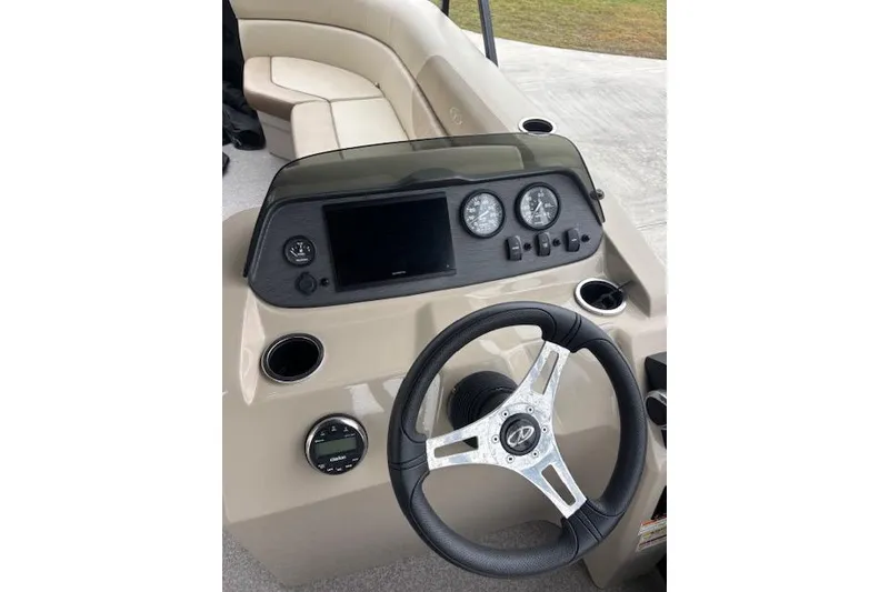 Slide: The Image of 2022 Veranda Vista 22RC boat dashboard with steering wheel and gauges. - 10