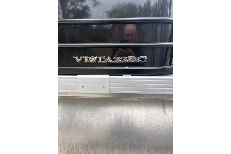 Slide: The Image of 2022 Veranda Vista 22RC boat nameplate on a sleek black surface. - 14