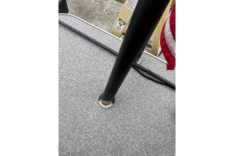 Slide: The Image of 2022 Veranda Vista 22RC boat deck with flagpole and carpeted surface. - 15