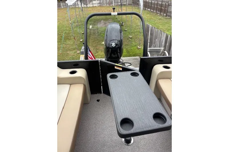 Slide: The Image of 2022 Veranda Vista 22RC boat interior with table and seating, featuring an outboard motor. - 18