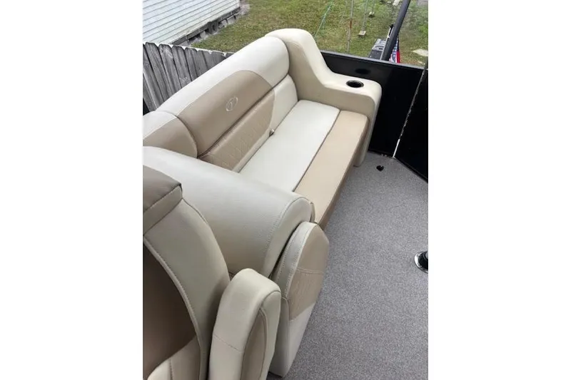 Slide: The Image of 2022 Veranda Vista 22RC boat interior with beige seating and cup holder. - 20