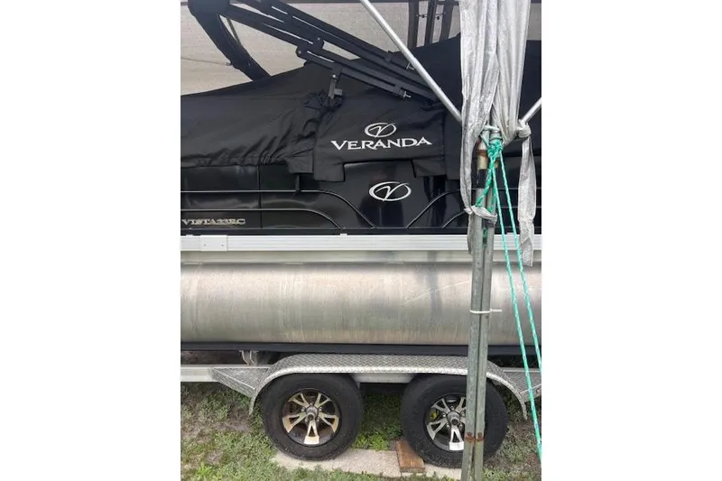 Slide: The Image of 2022 Veranda Vista 22RC pontoon boat covered on a trailer. - 28