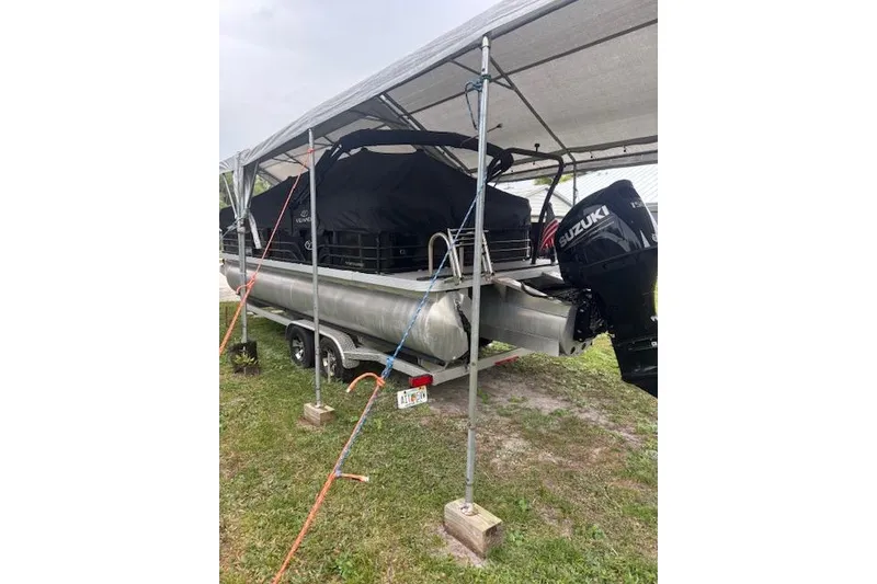 Slide: The Image of 2022 Veranda Vista 22RC pontoon boat with Suzuki engine under canopy. - 31