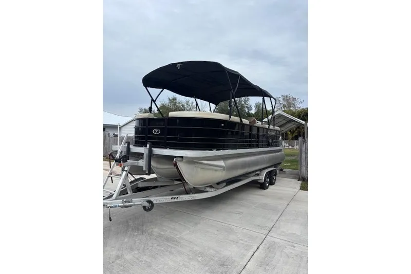 Slide: The Image of 2022 Veranda Vista 22RC pontoon boat on trailer with canopy, parked outdoors. - 4