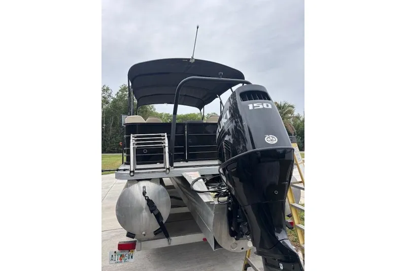 Slide: The Image of 2022 Veranda Vista 22RC pontoon boat with Suzuki 150 engine, parked on trailer. - 5
