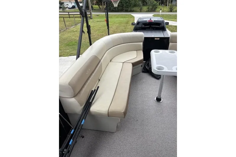Slide: The Image of 2022 Veranda Vista 22RC boat interior with beige seating and table. - 7