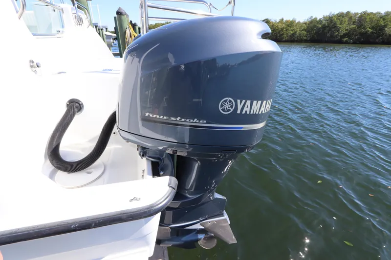Slide: The Image of Yamaha four-stroke engine on 2008 Glacier Bay 3080 Coastal Runner boat by the water. - 13