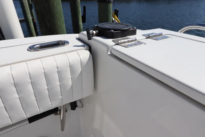 Slide: The Image of 2008 Glacier Bay 3080 Coastal Runner boat interior with white cushioned seating and storage compartment. - 17