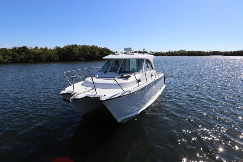 Slide: The Image of 2008 Glacier Bay 3080 Coastal Runner boat on calm water under clear blue sky. - 2
