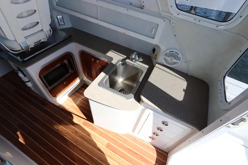 Slide: The Image of 2008 Glacier Bay 3080 Coastal Runner interior with sink, countertop, and wood flooring. - 34