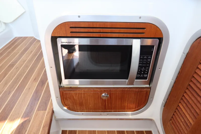 Slide: The Image of Microwave in 2008 Glacier Bay 3080 Coastal Runner boat kitchen, wood paneling. - 35