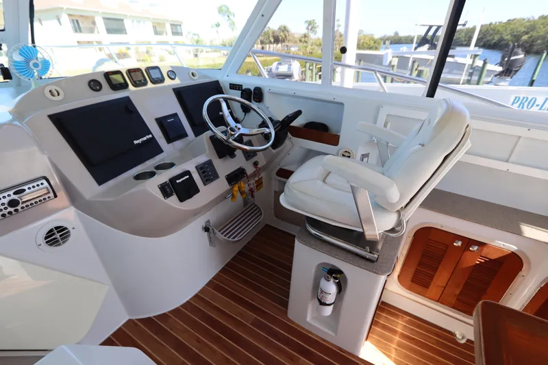 Slide: The Image of 2008 Glacier Bay 3080 Coastal Runner helm with steering wheel and navigation controls. - 38