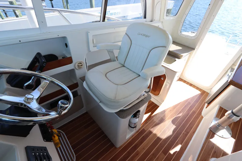 Slide: The Image of 2008 Glacier Bay 3080 Coastal Runner helm with captain's chair and steering wheel. - 39