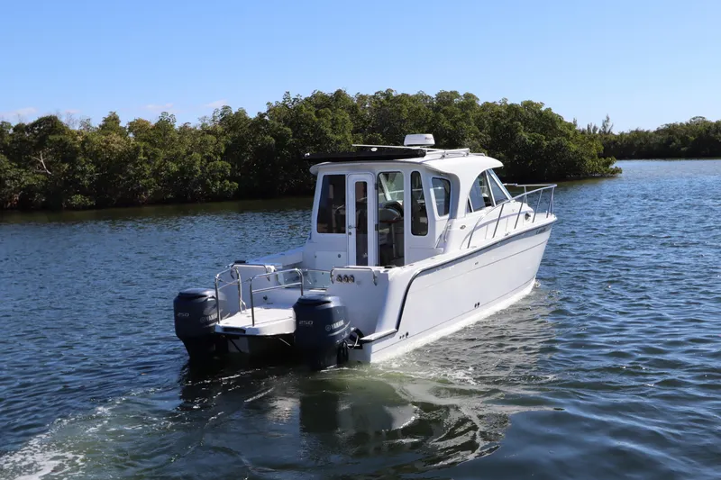 Slide: The Image of 2008 Glacier Bay 3080 Coastal Runner boat cruising on a serene waterway. - 4