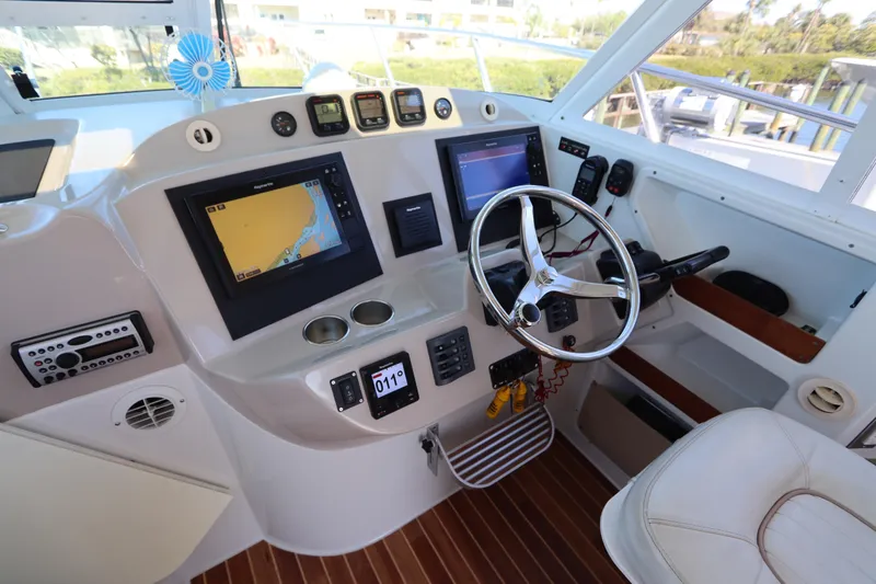 Slide: The Image of 2008 Glacier Bay 3080 Coastal Runner helm with navigation screens and steering wheel. - 40