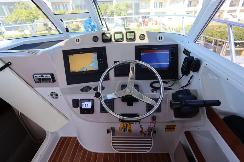Slide: The Image of Helm of 2008 Glacier Bay 3080 Coastal Runner with navigation screens and controls. - 41