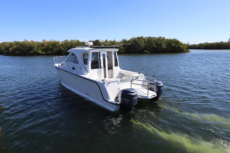 Slide: The Image of 2008 Glacier Bay 3080 Coastal Runner boat cruising on a serene lake. - 5