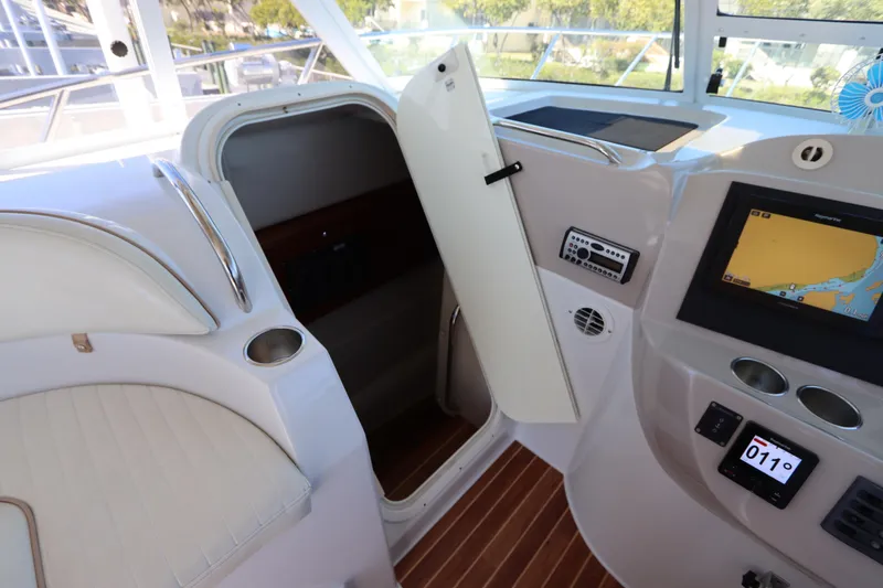 Slide: The Image of 2008 Glacier Bay 3080 Coastal Runner interior with navigation system and open cabin door. - 50