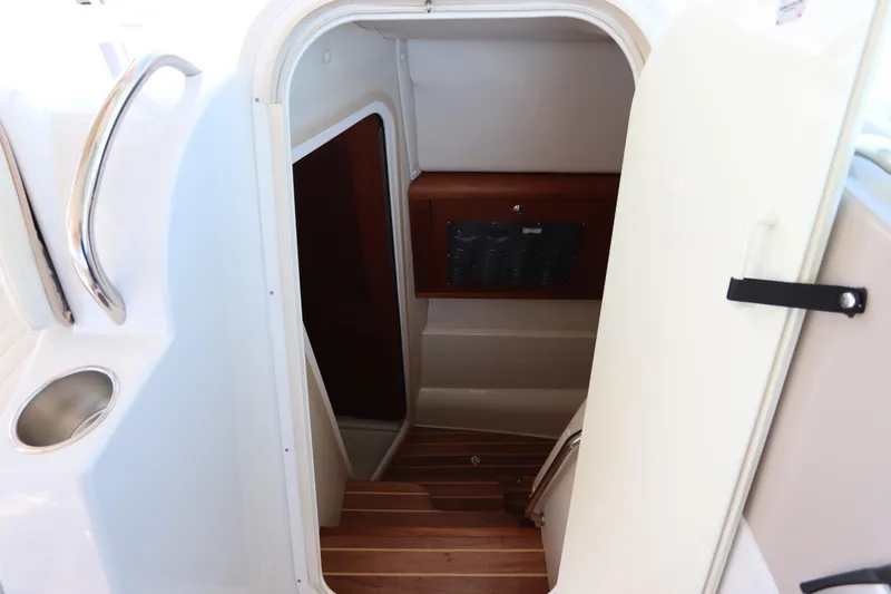 Slide: The Image of 2008 Glacier Bay 3080 Coastal Runner cabin entrance with wooden steps and control panel. - 51