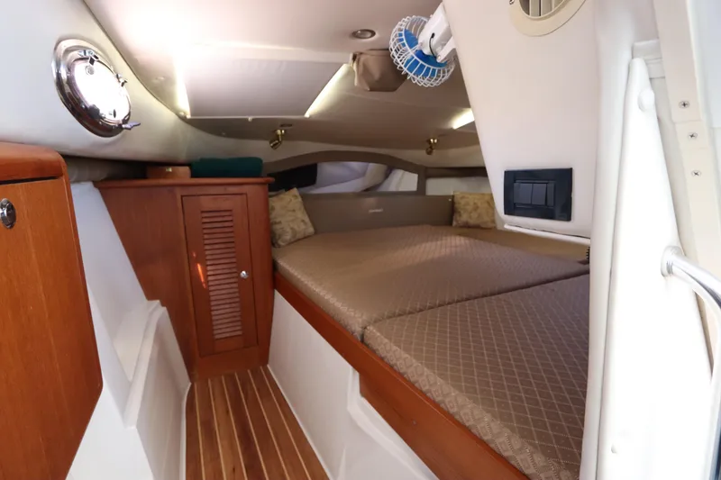 Slide: The Image of 2008 Glacier Bay 3080 Coastal Runner cabin interior with wood accents and cozy bedding. - 53