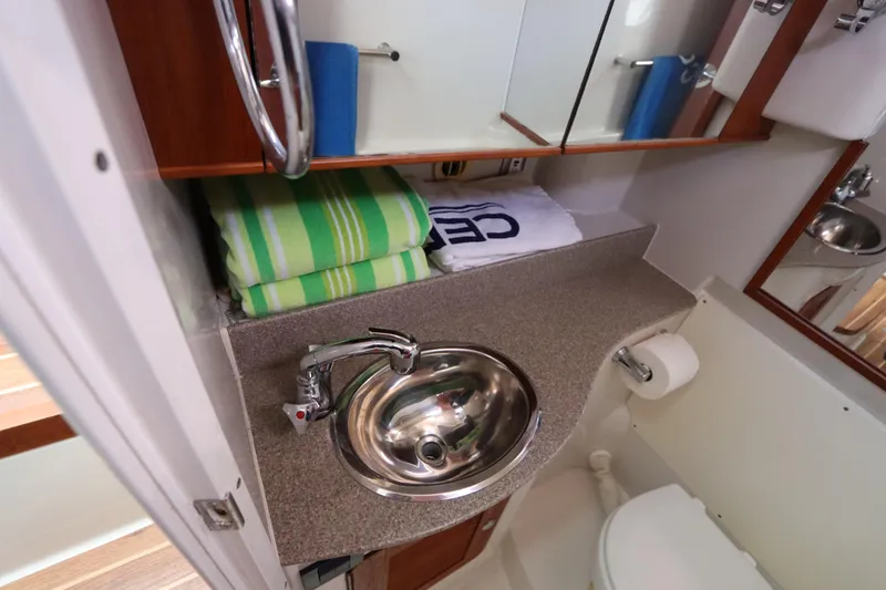 Slide: The Image of 2008 Glacier Bay 3080 Coastal Runner bathroom with sink, mirror, and towels. - 57