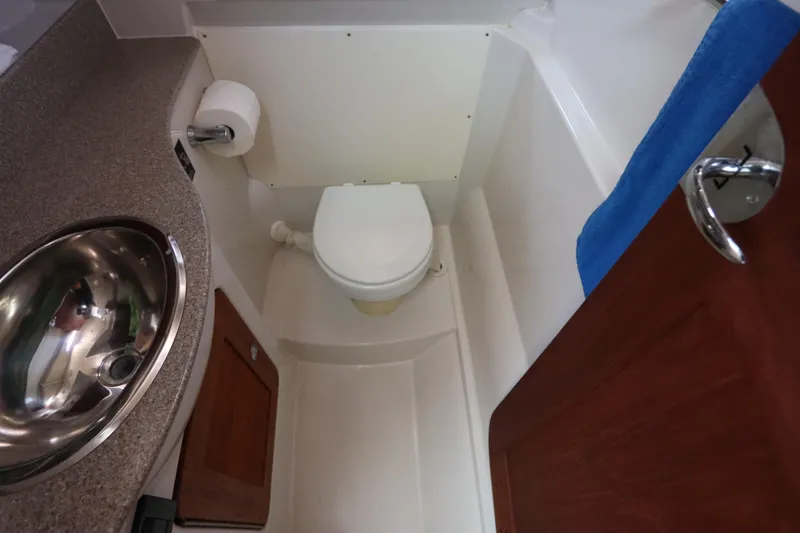 Slide: The Image of Compact bathroom in 2008 Glacier Bay 3080 Coastal Runner boat, featuring sink and toilet. - 58