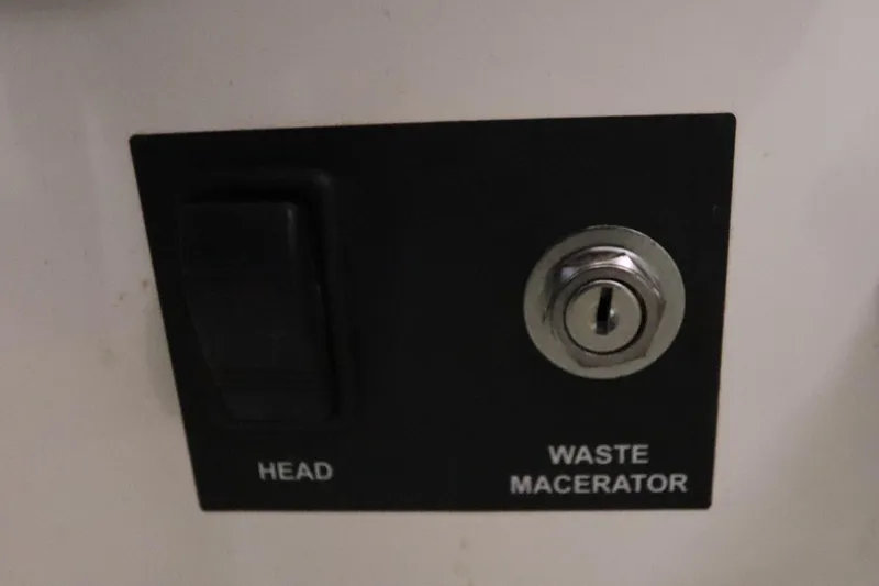 Slide: The Image of Control panel for head and waste macerator on 2008 Glacier Bay 3080 Coastal Runner. - 59