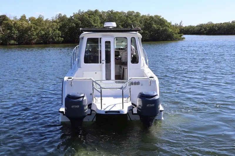 Slide: The Image of 2008 Glacier Bay 3080 Coastal Runner boat on water, rear view with twin engines. - 6