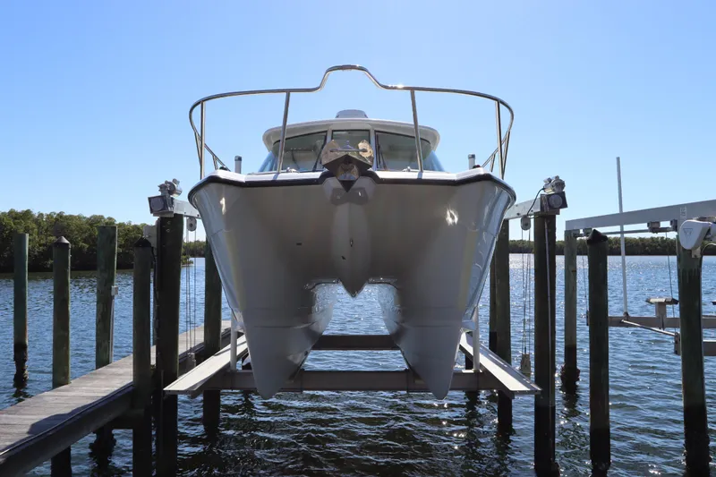 Slide: The Image of 2008 Glacier Bay 3080 Coastal Runner boat on lift at marina dock. - 8