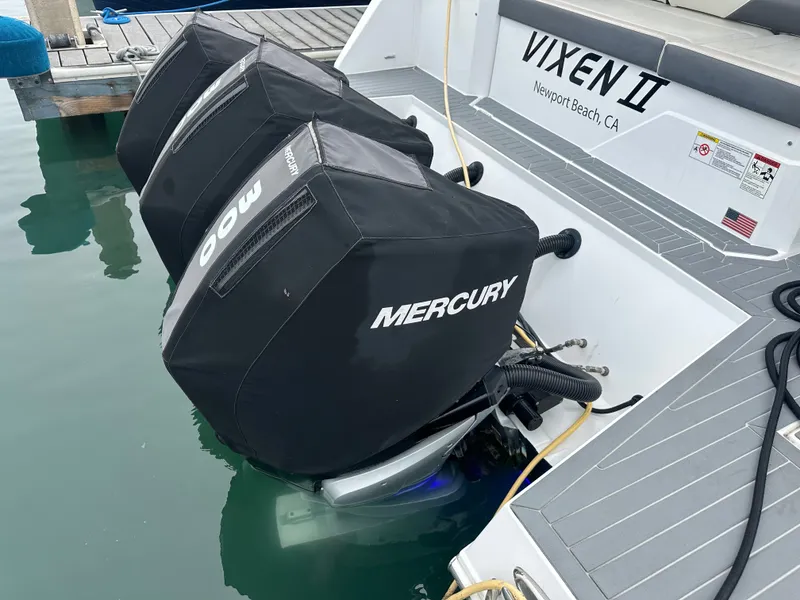 Slide: The Image of The image shows two Mercury outboard engines on a Cruisers Yachts 38 GLS boat in the water. - 7