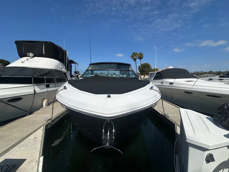Slide: The Image of A 2021 Cruisers Yachts 38 GLS docked at a marina, surrounded by other boats. - 30