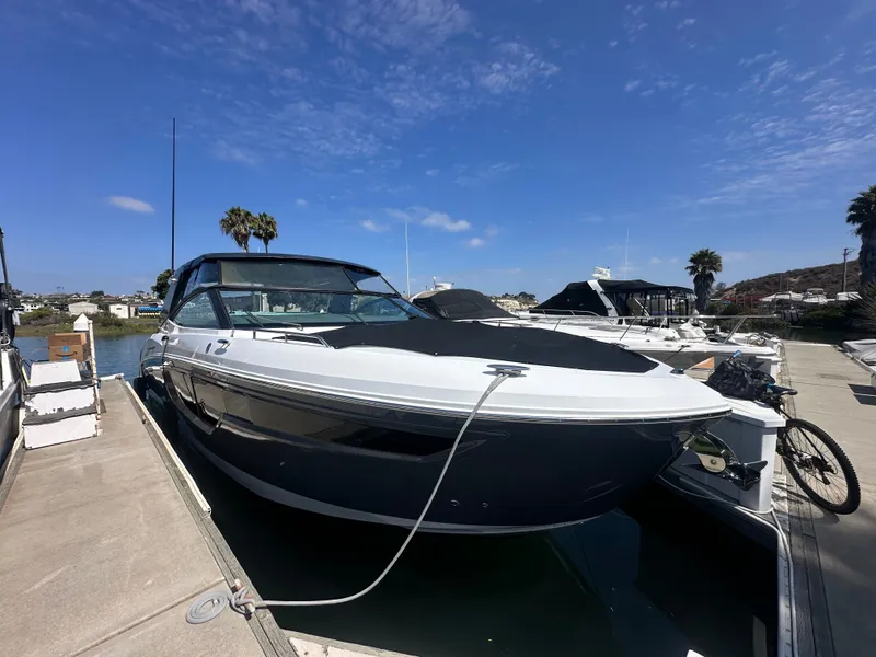 Slide: The Image of A 2021 Cruisers Yachts 38 GLS docked under a sunny sky. - 28