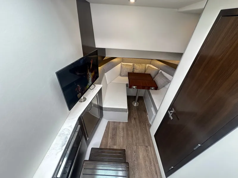 Slide: The Image of Interior of a 2021 Cruisers Yachts 38 GLS with a cozy seating area and TV. - 27