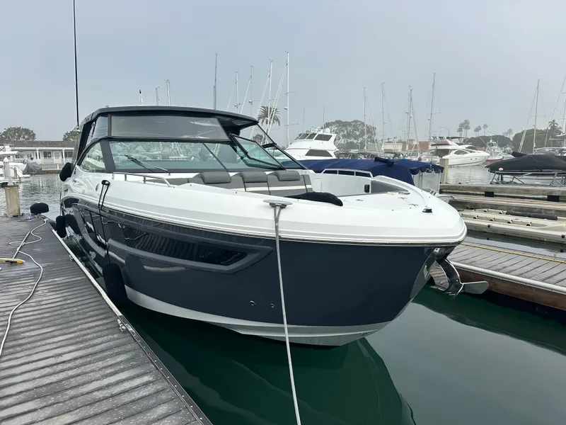 Slide: The Image of A modern 2021 Cruisers Yachts 38 GLS docked at a marina, surrounded by other boats. - 8