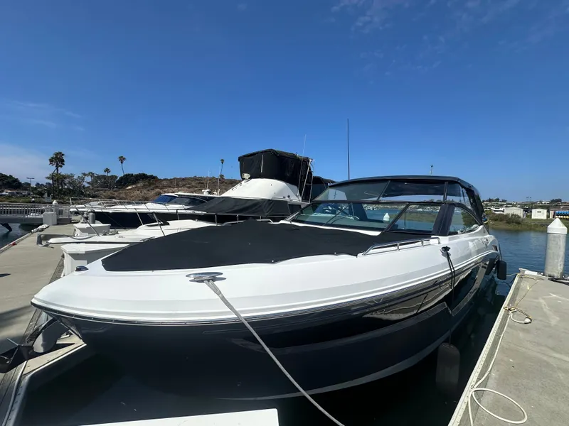 Slide: The Image of A 2021 Cruisers Yachts 38 GLS docked under a sunny sky. It features a sleek design. - 31
