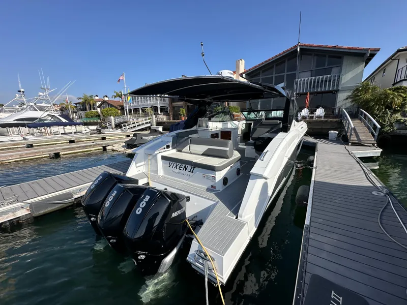 Slide: The Image of A luxury motor yacht with twin outboard engines docked. It features a spacious deck area. - 22