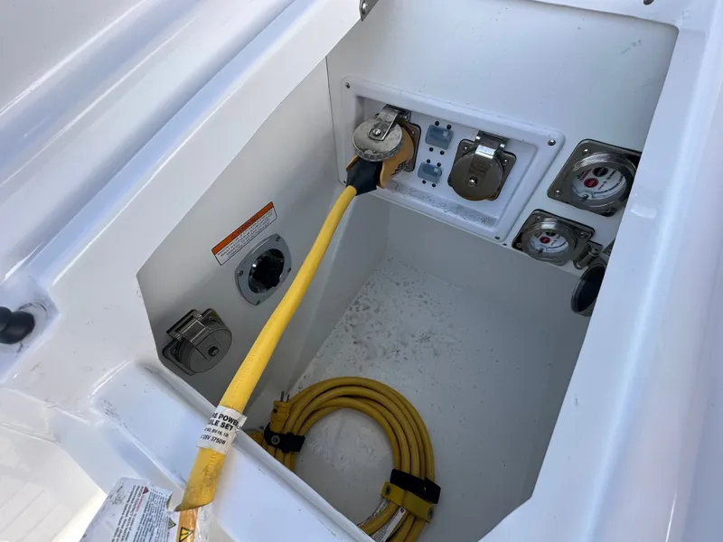Slide: The Image of A storage compartment on a Cruisers Yachts 38 GLS boat with yellow cable and connectors. - 47
