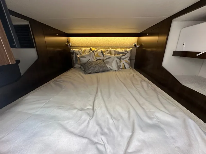 Slide: The Image of A cozy bed in a yacht cabin with pillows and soft lighting. - 37
