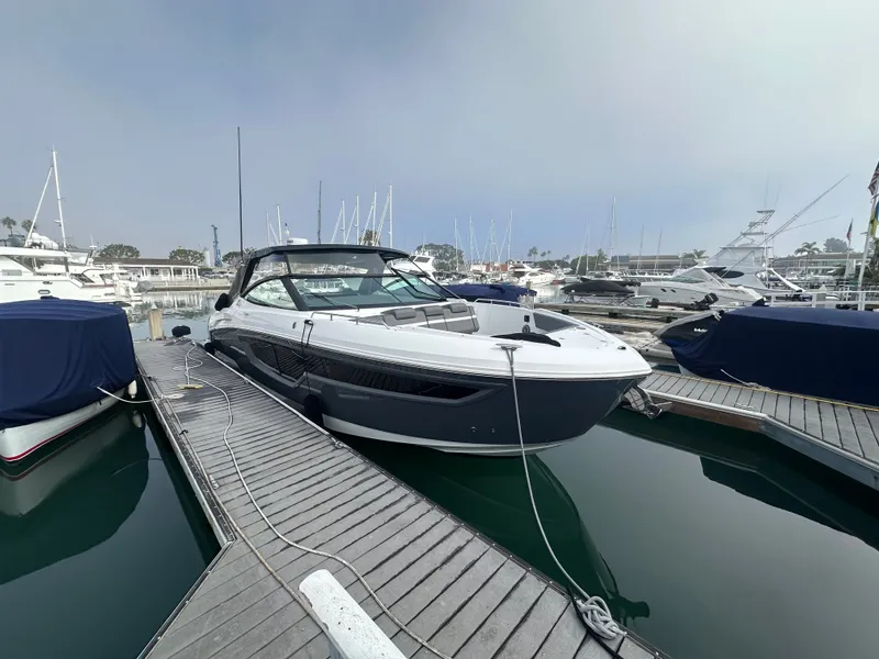Slide: The Image of A modern yacht docked at a marina, with other boats visible in the background. - 11