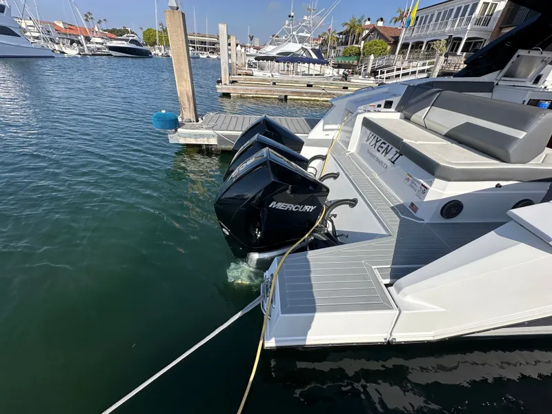 Slide: The Image of A 2021 Cruisers Yachts 38 GLS docked. Three Mercury outboard engines are visible. - 44
