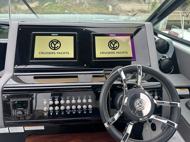 Slide: The Image of The 2021 Cruisers Yachts 38 GLS cockpit features a modern dashboard with two display screens. - 20