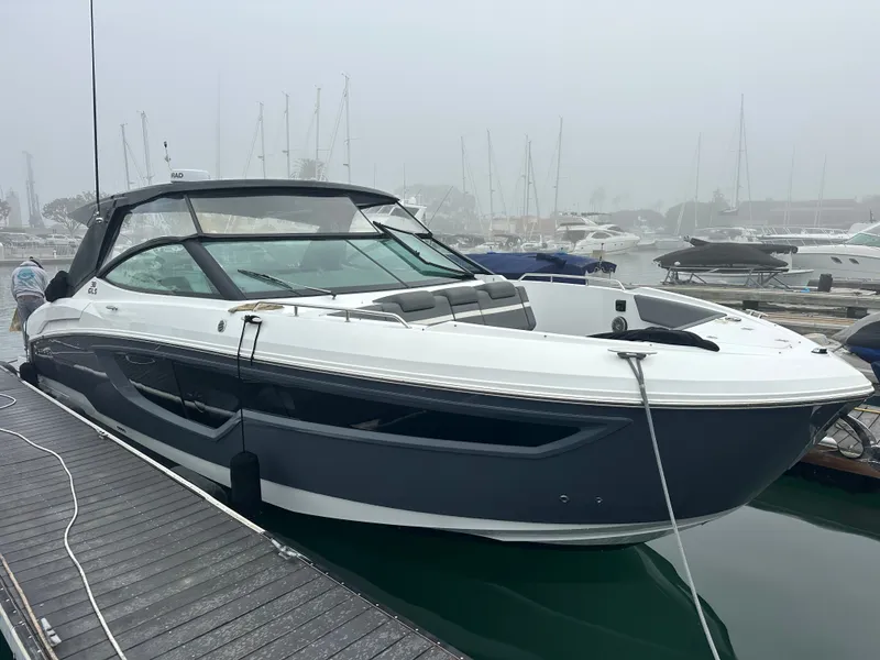 Slide: The Image of A modern motor yacht docked at a pier. It features sleek design and a spacious deck. - 2